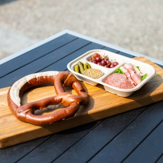 Pretzel and protein plate on a wood board