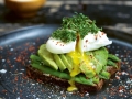 Poached egg on avocado toast on a plate 