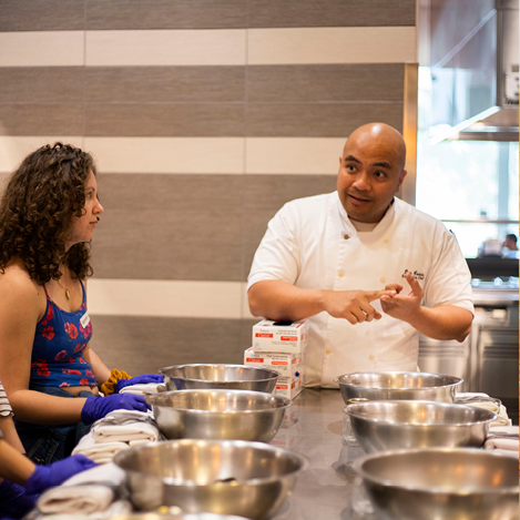 Chef Don Cortes with students in kitchen 