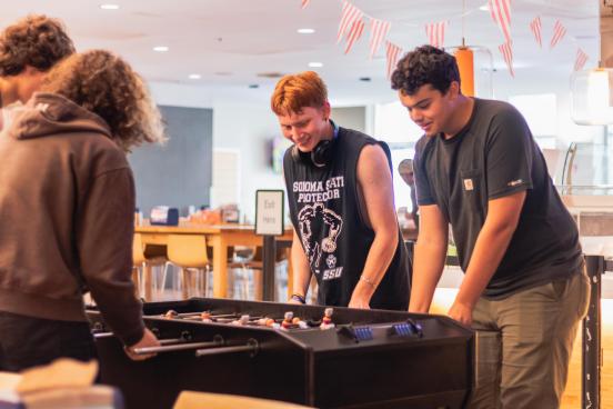 Students playing foose-ball