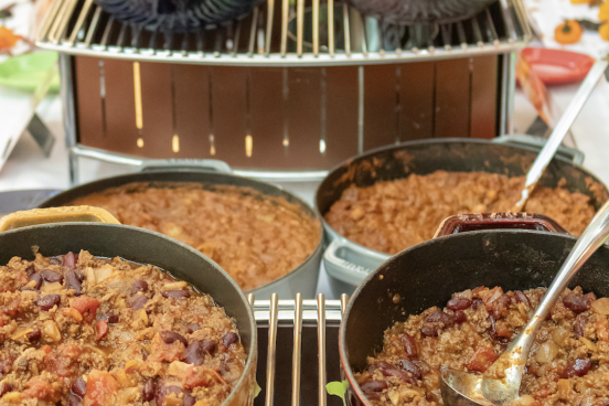 six bowls of chili on a tiered table