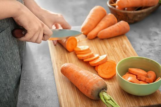 knife cutting carrots 