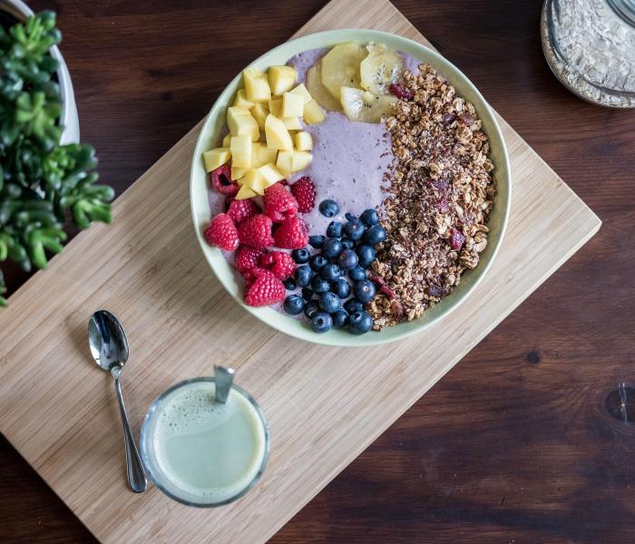 Yogurt in a large bowl with blueberries, raspberries, pineapple and grains