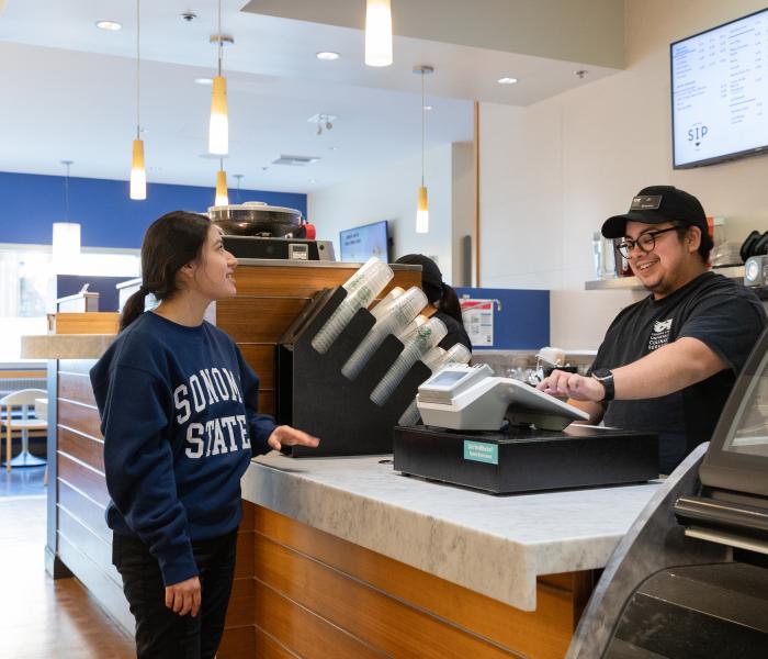 student buying food from a student worker