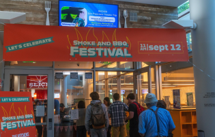 entrance to venue with orange event banner