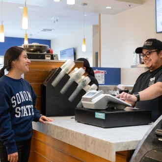 Student ordering at the counter with a cashier at a register