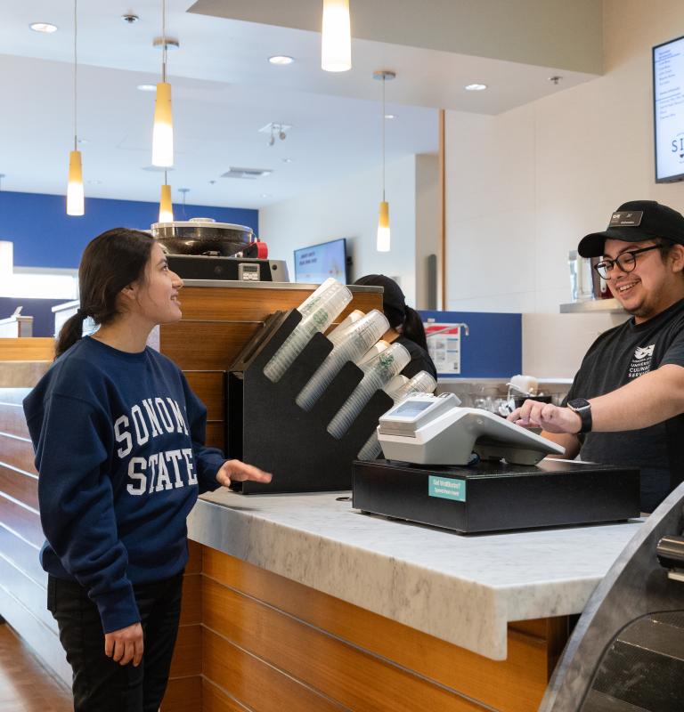 student buying food from a student worker