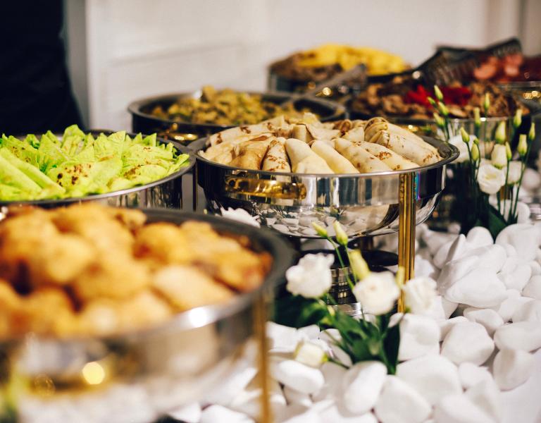 Catering setup with food in trays