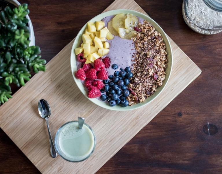 Yogurt in a large bowl with blueberries, raspberries, pineapple and grains