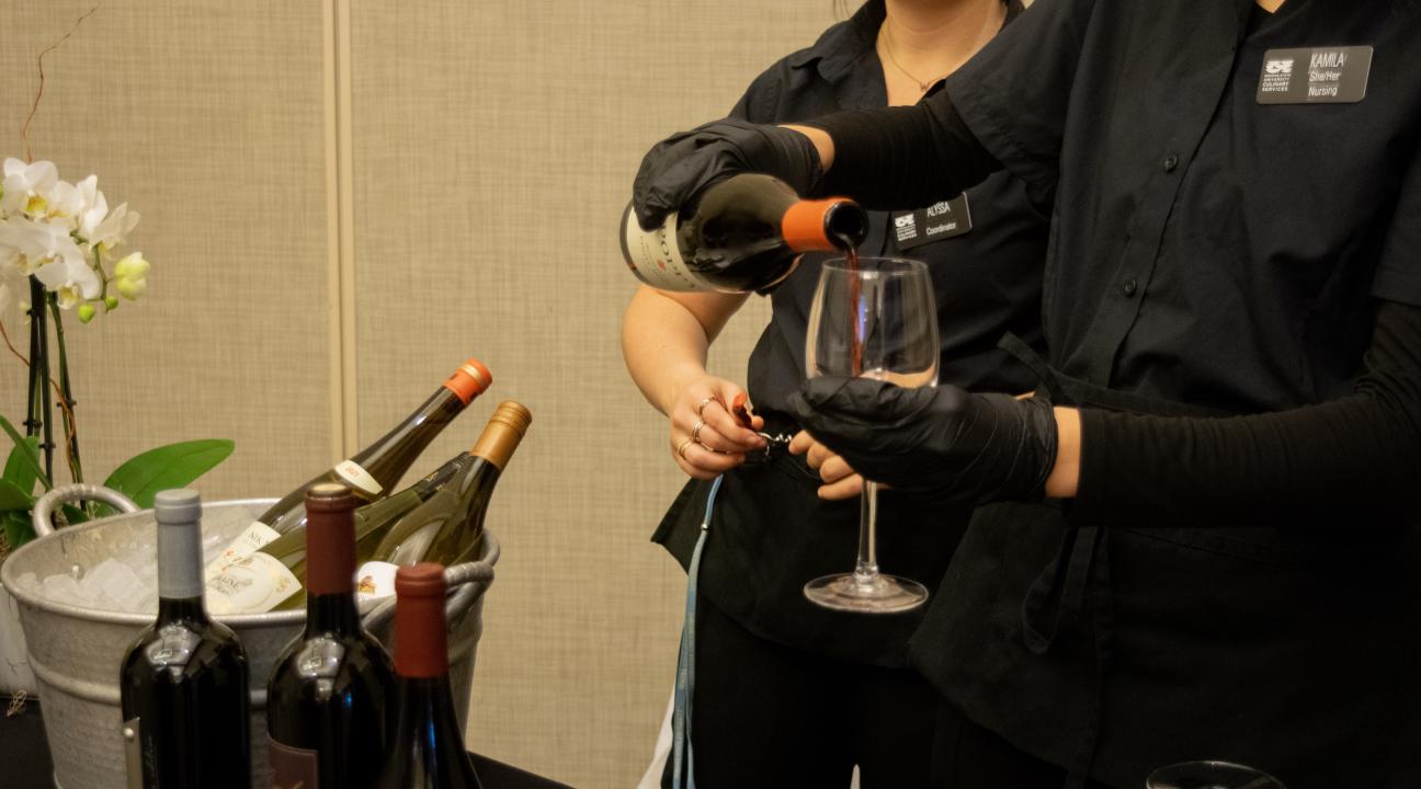 Employees pouring wine 