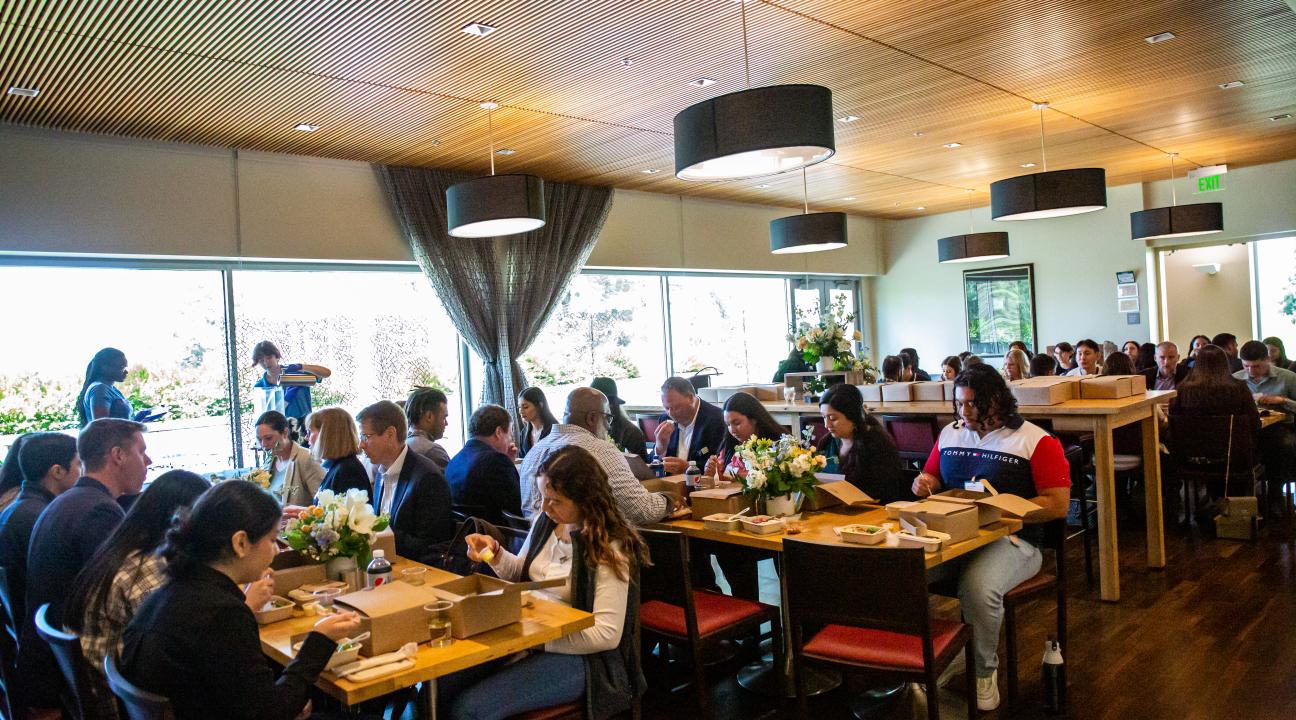 Attendees eating at tables