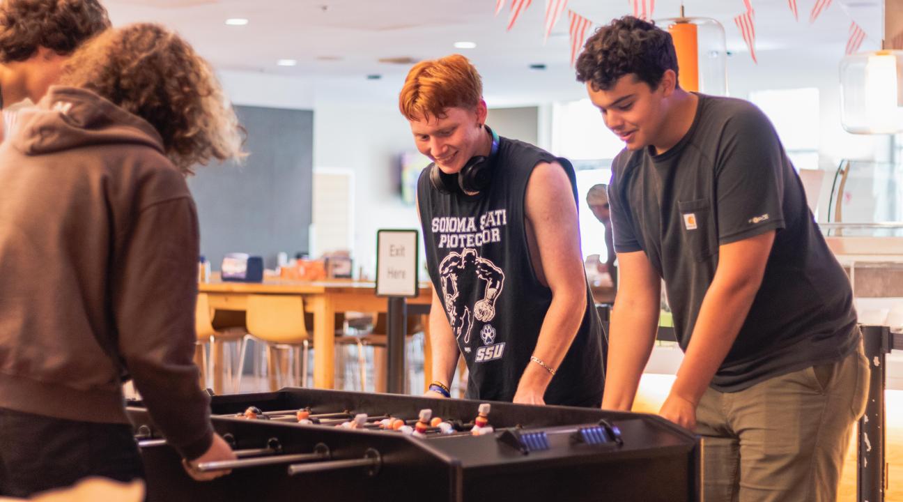 Students playing foose-ball