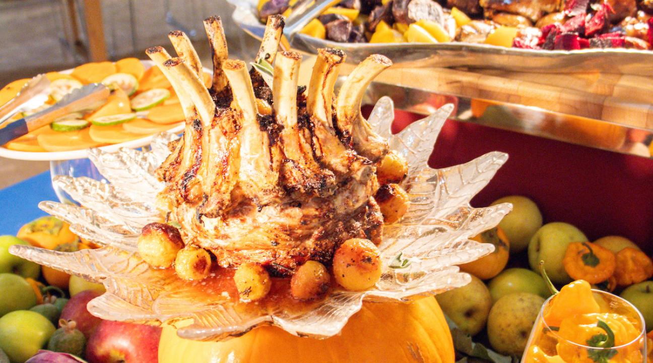 a table with decorated pumpkins and dinner dishes