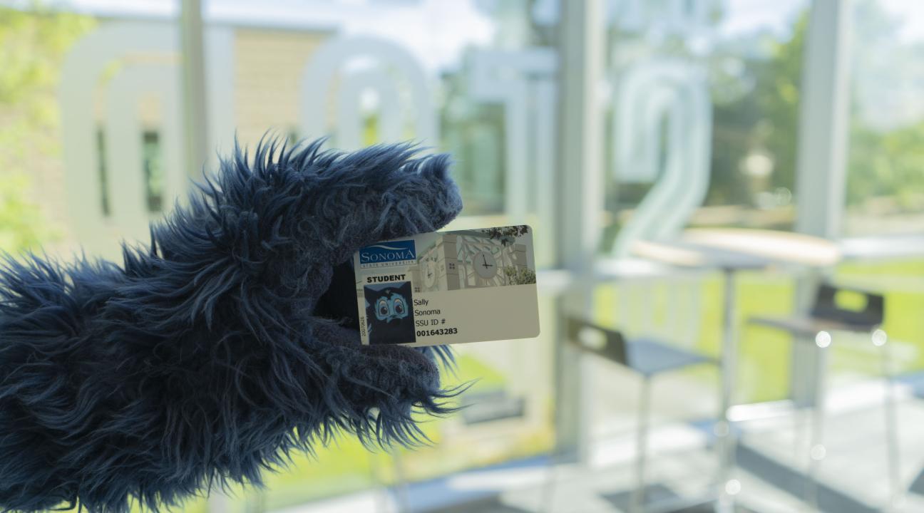 Lobo holding an ID card