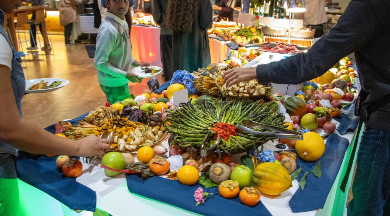 a display of asparagus and fruit