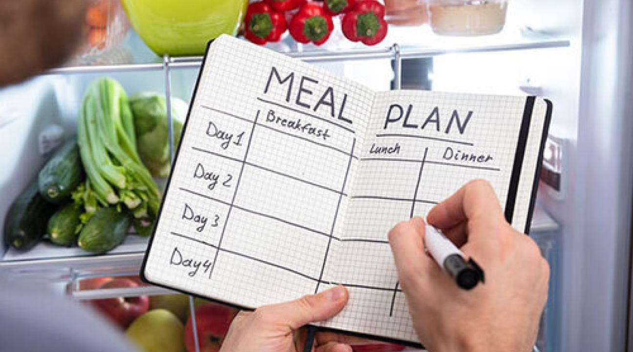 Meal plan journal notebook in someones hands