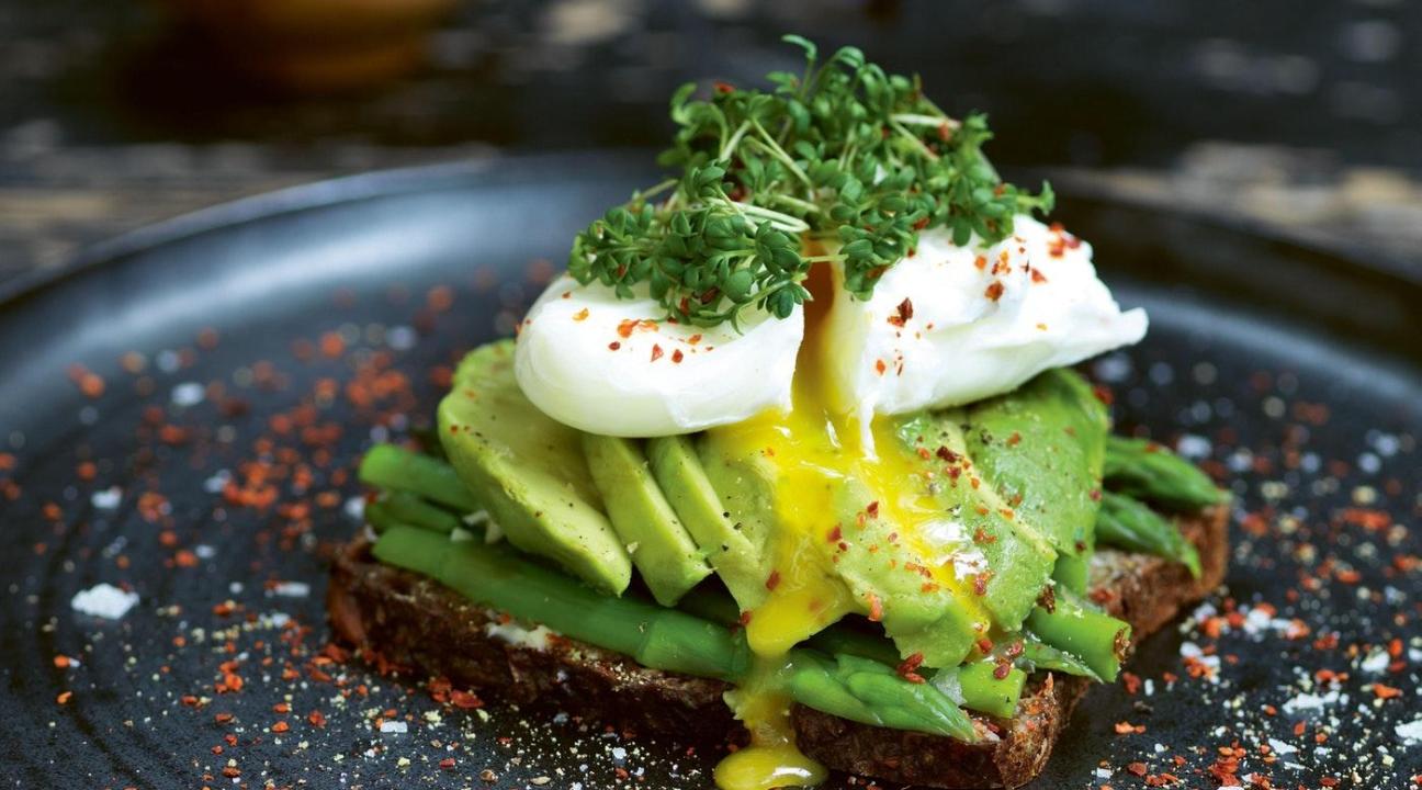 Poached egg on avocado toast on a plate 