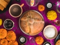 a table with a purple cloth and pan de muerto