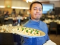 Student employee holding food plate 