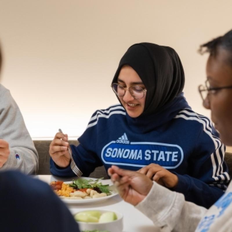 student eating at the kitchens