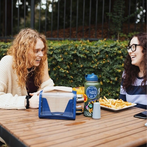 two students laughing at a table