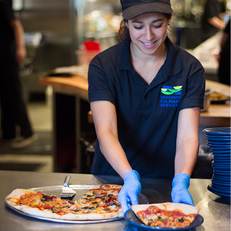 person with gloves serving food