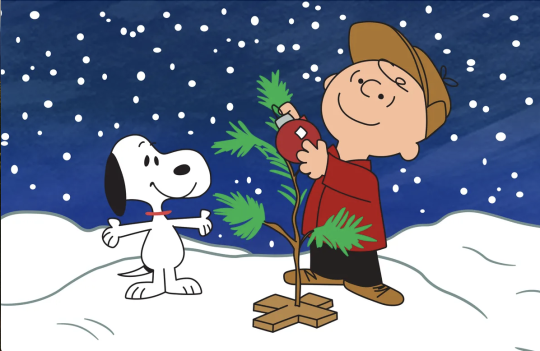 Char and snoopy setting up a christmas tree