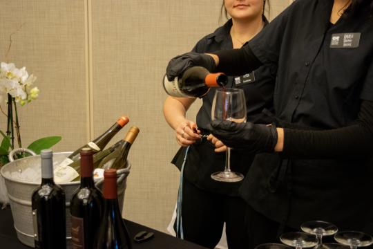 Employees pouring wine 