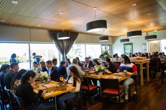 Attendees eating at tables