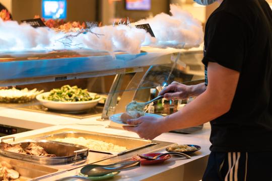 Student eating at the Kitchens