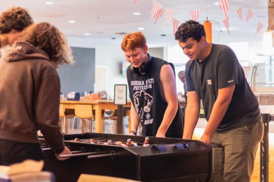 Students playing foose-ball