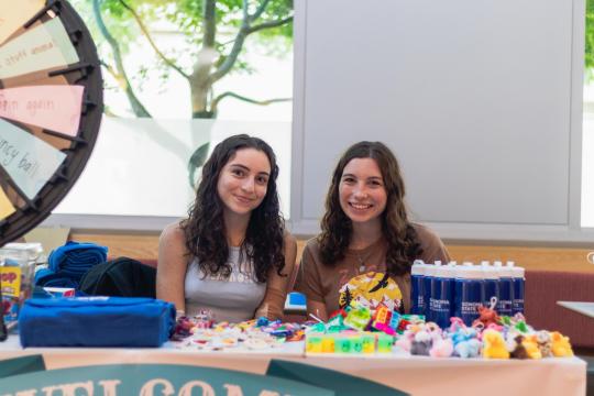 Two students sitting the prize wheel