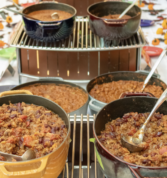 six bowls of chili on a tiered table