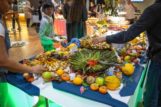 a display of asparagus and fruit