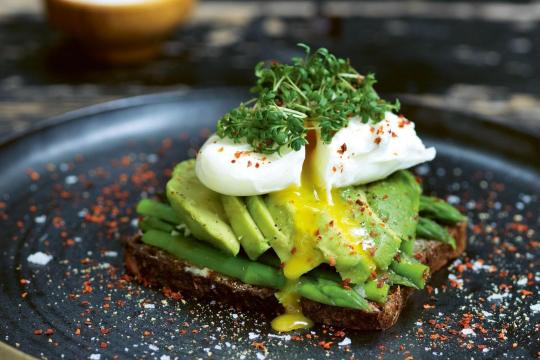 Poached egg on avocado toast on a plate 