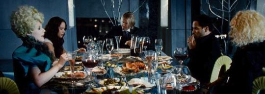 a table filled with plates of food and wine glasses