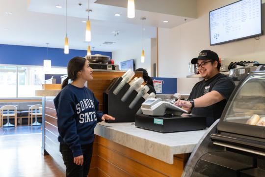 student buying food from a student worker