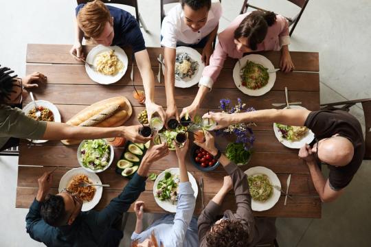 A group of people sitting around a table full of food