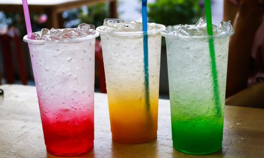 Three Italian sodas sitting on a table 