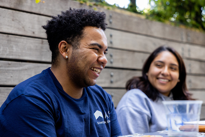 two students laughing together at a table