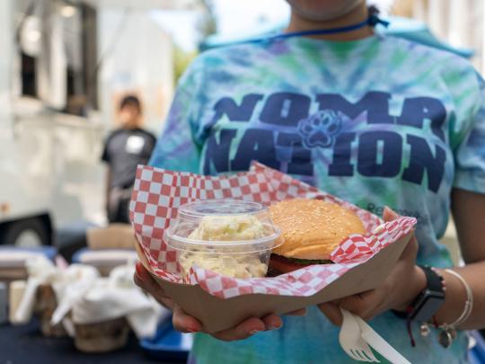 student holding food